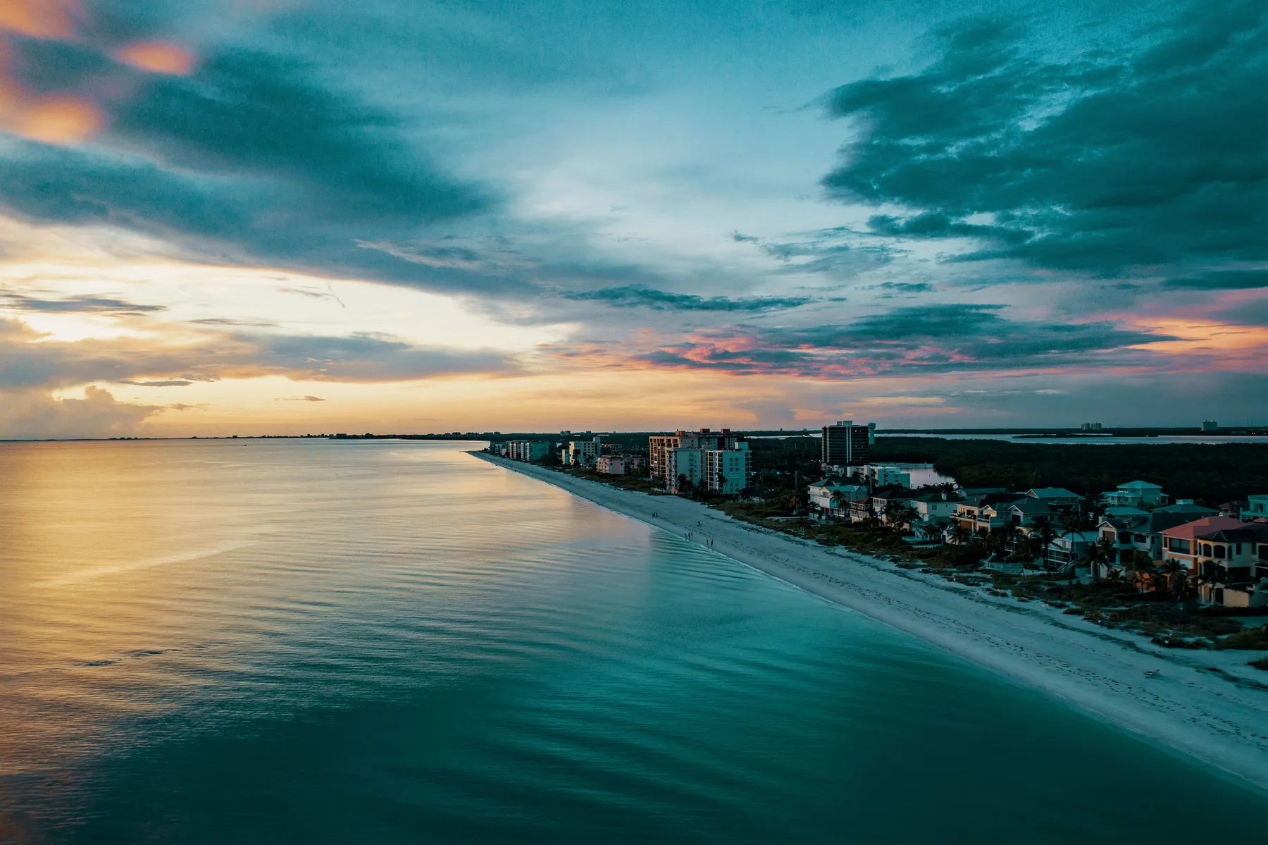 Aerial view of beachfront real estate at sunset — Sonder Studio web design for real estate